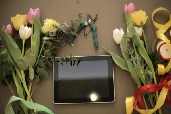 Tablet and flower bunches on floral shop counter